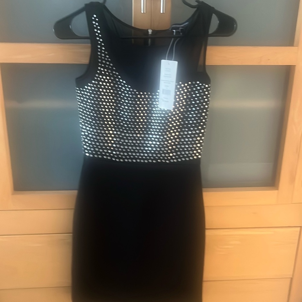 Brand New with tags. Diamond studs, black dress